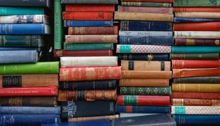 A large stack of multi-coloured books.