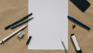 plain piece of paper with pens surrounding it